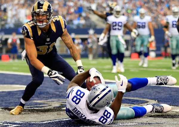 Unfortunately, this happened all too often when Cortland Finnegan was a pass defender in 2013. (Jamie Squire/Getty Images)